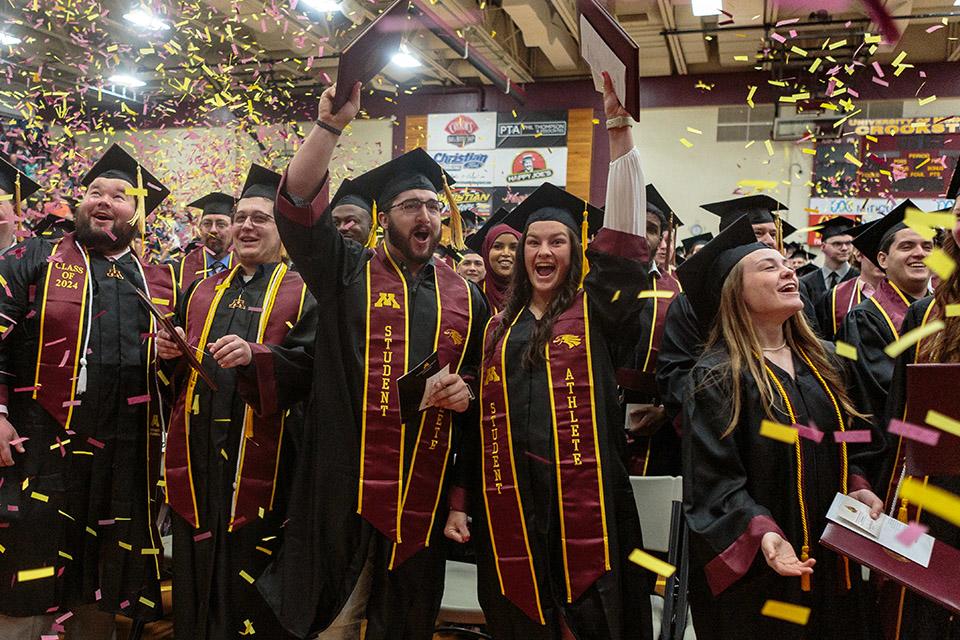 A bunch of graduating students celebrating with confetti during Commencement 2024.
