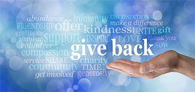 Word cloud with hand holding the words "give back"