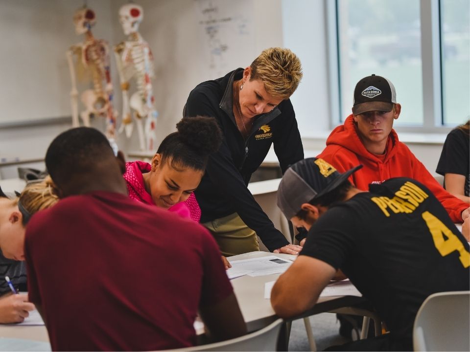 Students in a Exercise and Wellness class with faculty member answering questions