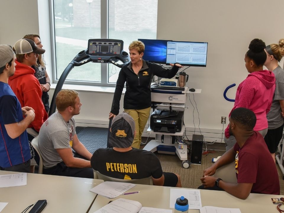 Faculty member teaching students in the Exercise Science and Wellness program in the Wellness Center
