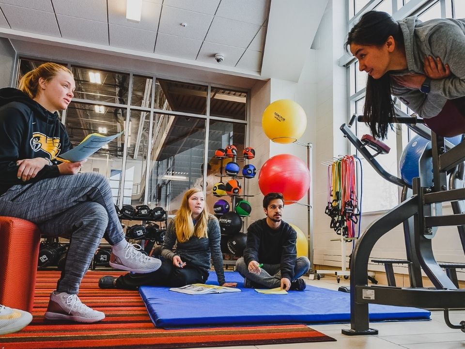 Four students in the Wellness Center working on a project