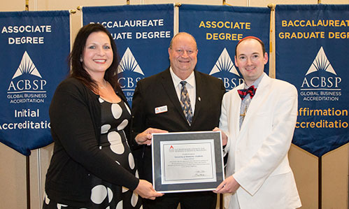  The UMC Business Department receives the candidate for accreditation certificate from the Chief Accreditation Officer of the ACBSP.