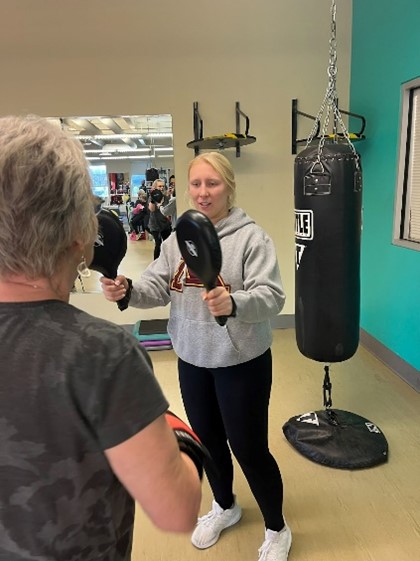 Kora Norland works one-on-one with a participant in the Rock Steady Boxing Parkinson's Program through the YMCA