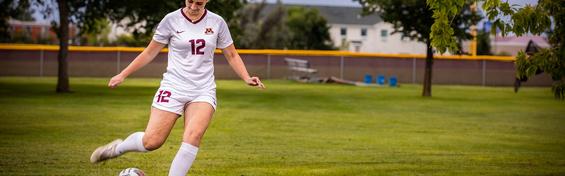 Katie Emmett kicking a soccer ball