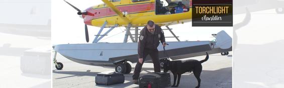 Chad Hornbaker and his dog Dock inspecting luggage at an airport