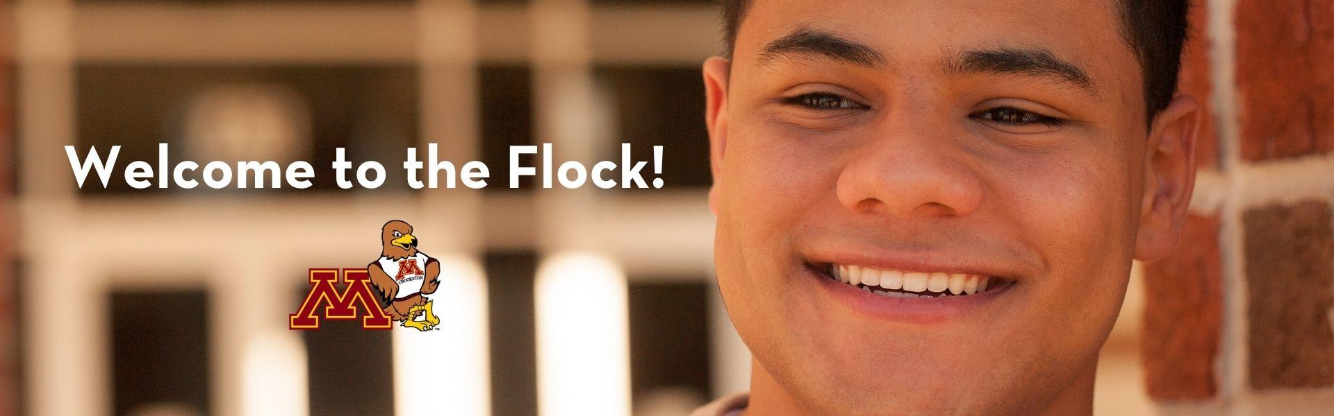 Happy male student with "Welcome to the Flock"