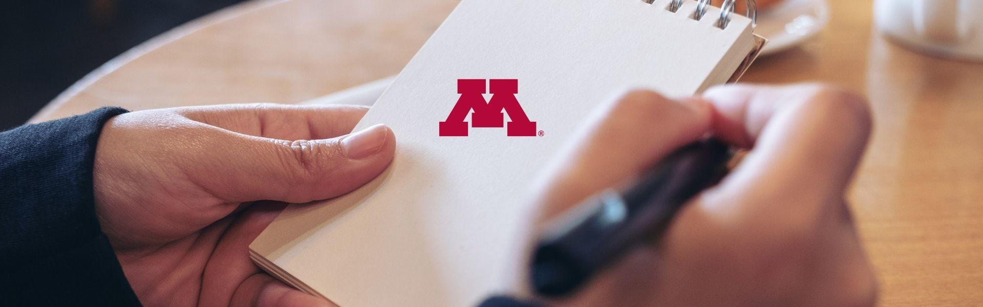 Notebook with University of Minnesota Block M on it