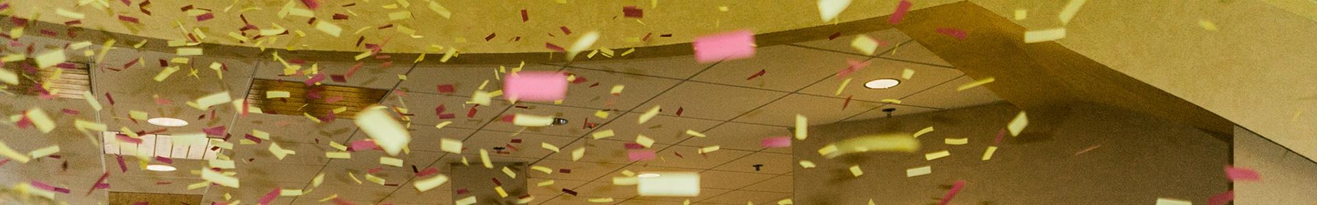 Confetti in the air in Kiehle Building Rotunda during the Torch & Shield Event
