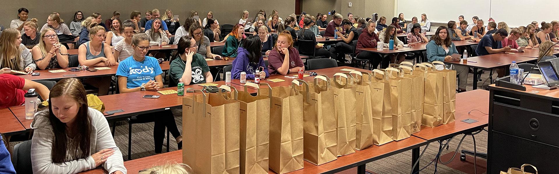 Students playing grocery bag bingo during a GEE event
