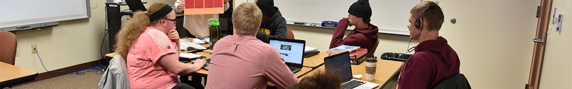 Student with assistive technology in the classroom at UMN Crookston