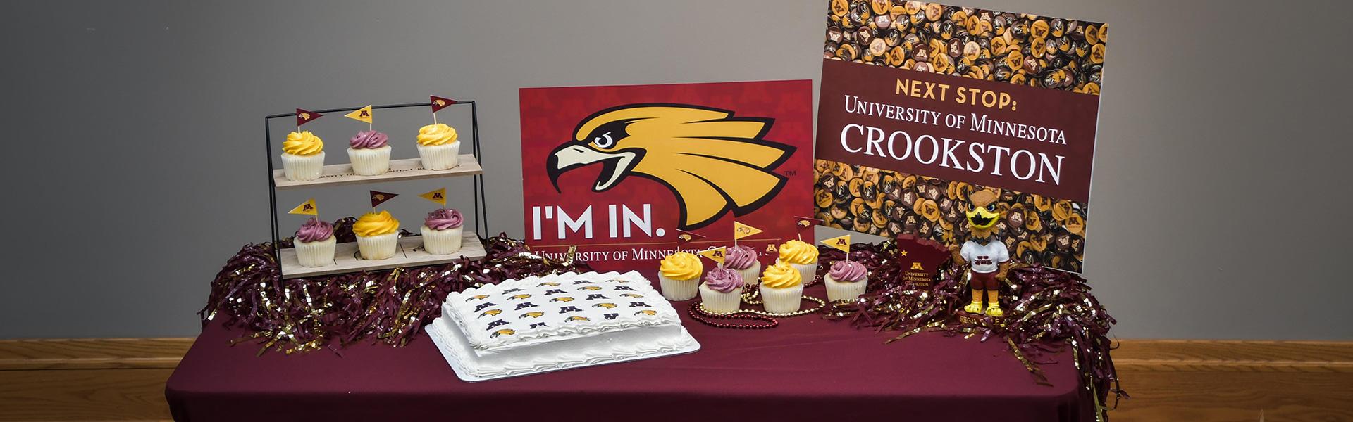 UMN Crookston Graduation Party Display with cupcake flags, cake design, and signage