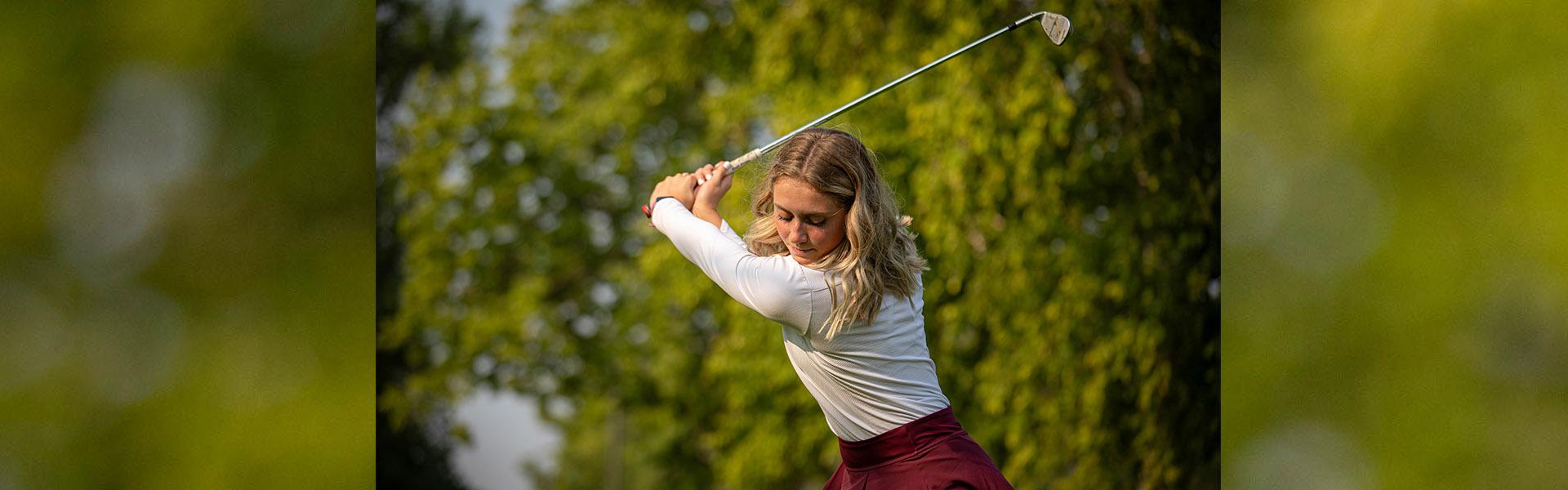 Clara Hanson, Golden Eagle Women's Golfer, tees off