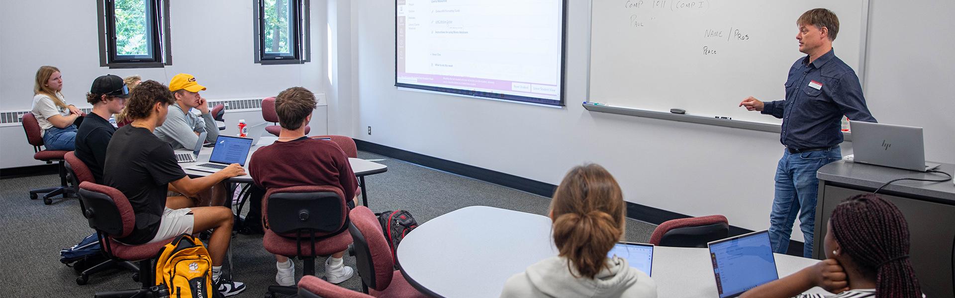 English class instructor teaching in front of a class of students