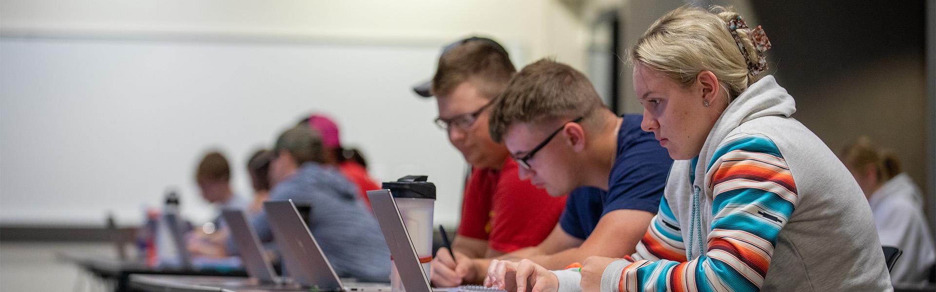 Several students working on their laptops in Heritage Hall Classrooms