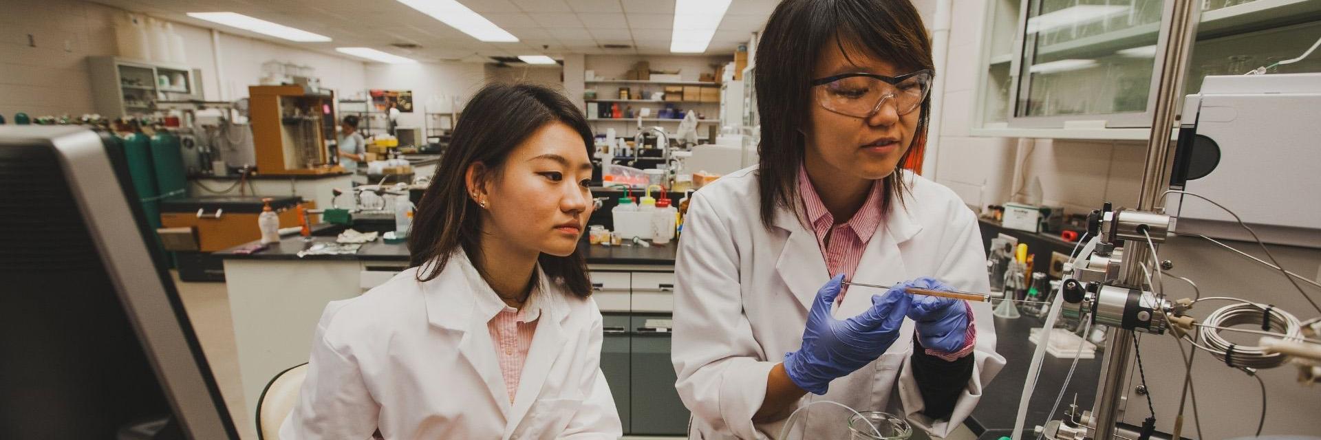 Two students working in a laboratory.