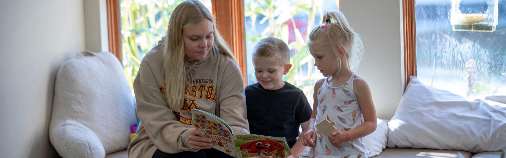 Mother reading a book to her children