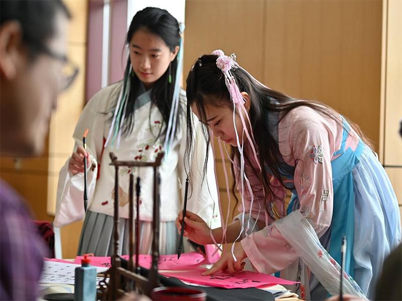 International students giving a demonstration on chinese calligraphy