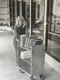 Student moves books to new library in 1979