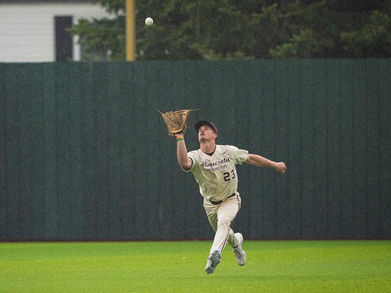 Baseball player catching a fly ball in the outfield