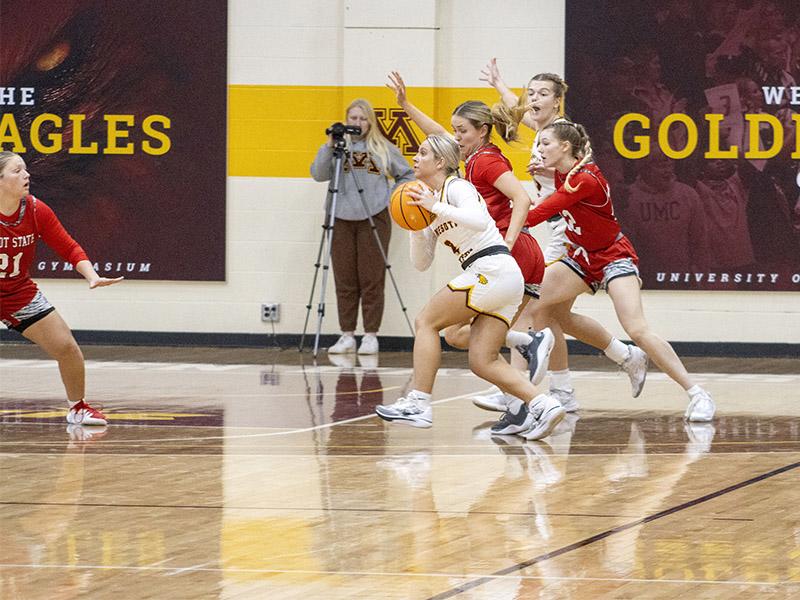 Golden Eagle women's basketball player driving up for a lay-up at home