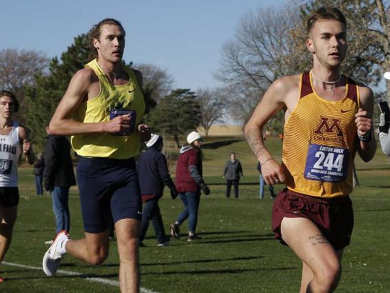 Golden Eagle men's cross country runner outfront of opponents