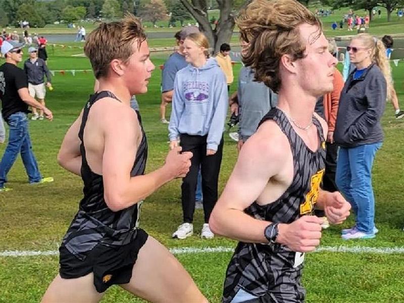 Golden Eagle men's cross country teammates competing against each other during a race