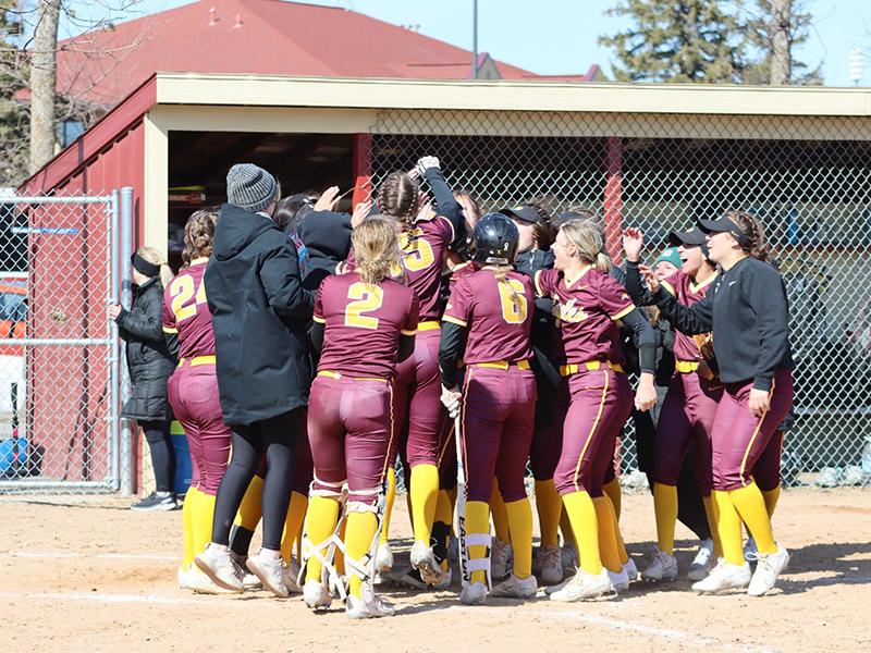 Golden Eagle women's softball team celebrating after a win at home
