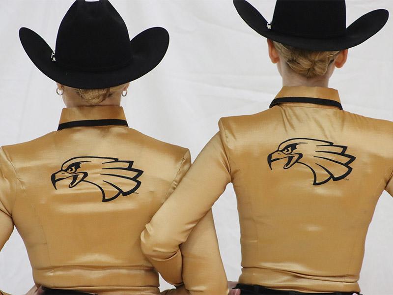 Two western athletes showing the backs of their uniforms