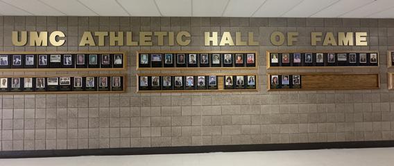 UMC Athletic Hall of Fame rows of photo plaques in the hallway of Lysaker Gymnasium