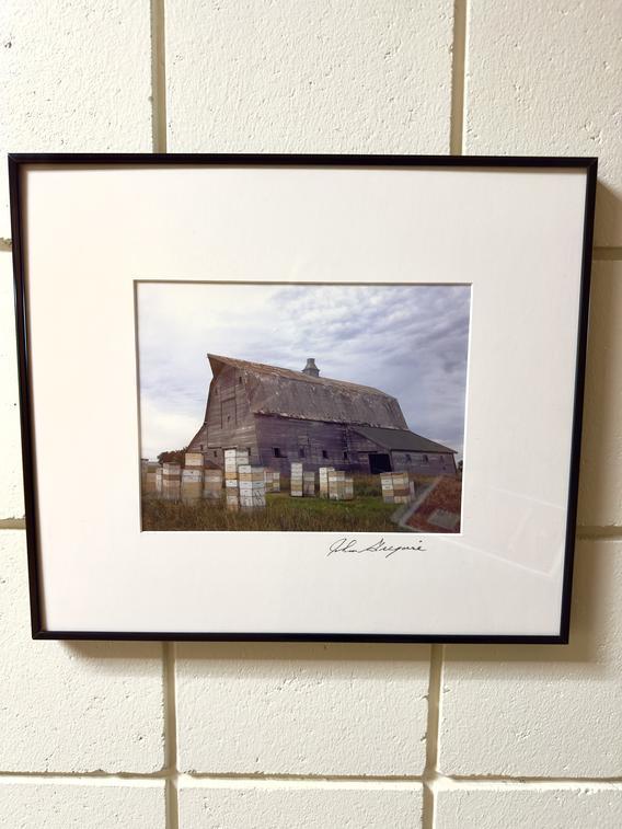 Framed photo of a an aged barn by John Gregoire hanging in Owen Hall on 2nd floor