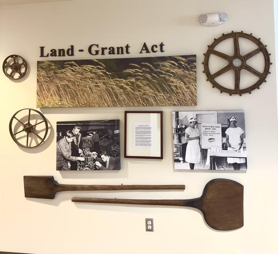 Land Grant Act Display on the wall of Heritage Hall first floor - photos, wheels and other artifacts