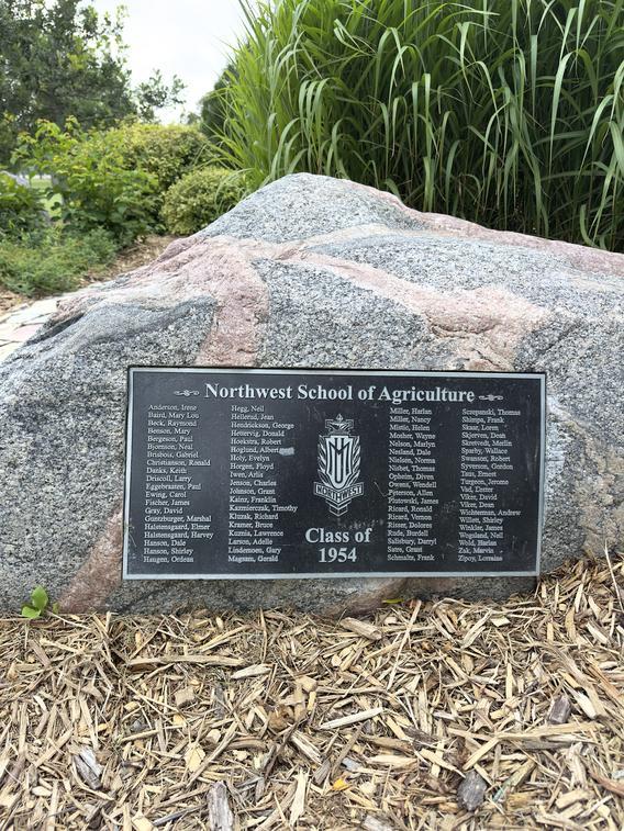 Large granite rock with memorial plaque attached in the Memorial Rock Garden