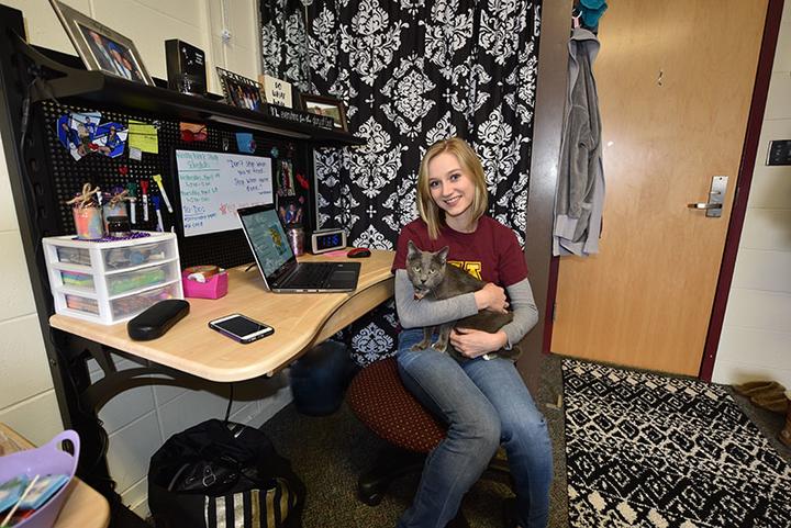 Female student with cat in a Skyberg Hall room