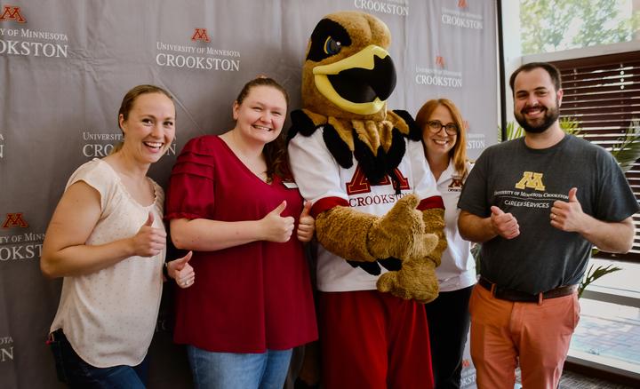 UMN Crookston staff members and Regal the Golden Eagle at The Nest on Broadway