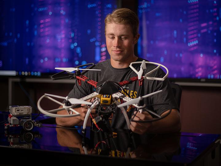 Student working with a drone