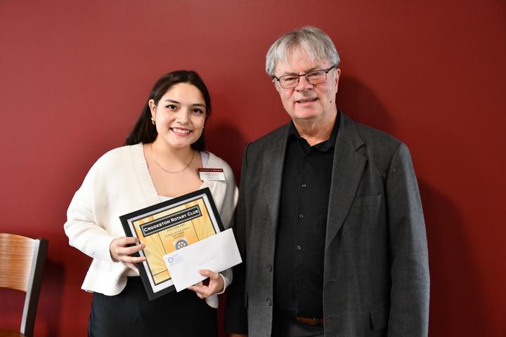 Student of the Semester Jackie Calderon stands with Rotary member George French