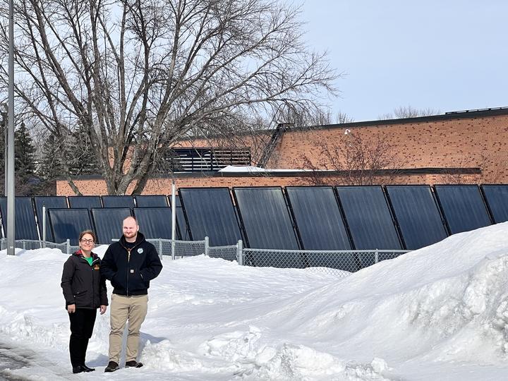 U of M Crookston students Zahra Pagirighalehnoei and Shelby Engels near the solar panels on the Morris campus