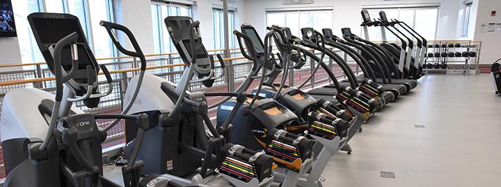 Cardio machines on floor two next to running track