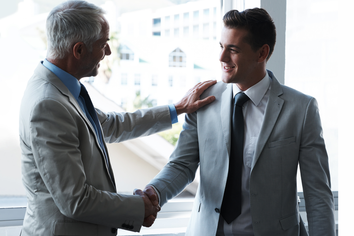 Two business men shaking hands.