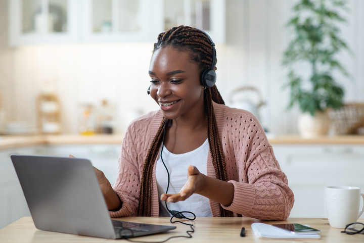 Image of a college student having a video call on her laptop.