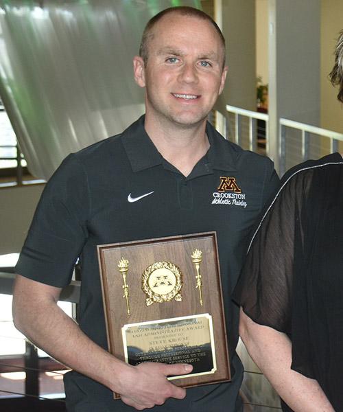 Steven Krouse with his Distinguished Professional and Administrative Award plaque outside of the Northern Lights Lounge