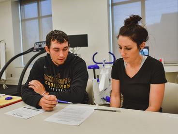 Two students helping each other in class