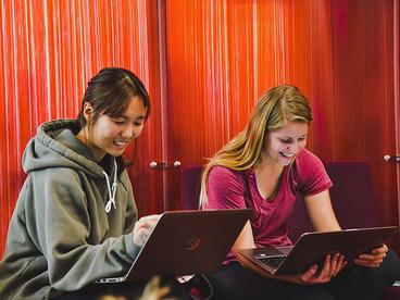 Two students on their laptops in the Wellness Center