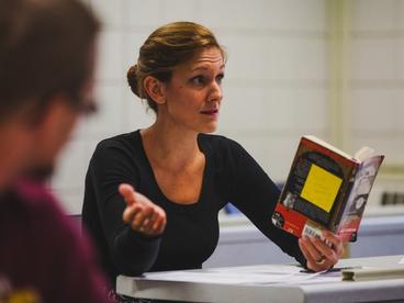 Professor Rachel McCoppin discussing a literature book during class.