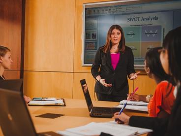 Courtney Bergman, faculty member, in the Business Board room conducting class