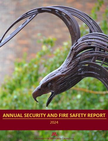 Annual Security and Fire Safety Report 2024 Cover with the metal Golden Eagle Statue next to greenery in the background