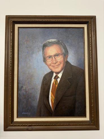 Framed painting of Bernie Youngquist hanging on the wall of the Northwest Research and Outreach Center.