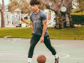 Basketball player on an outdoor court with a M Crookston shirt on