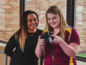 Two students looking at a digital camera image