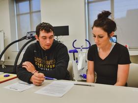 Two students working an assignment together in a health related class